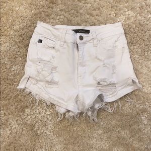 Distressed white jean shorts